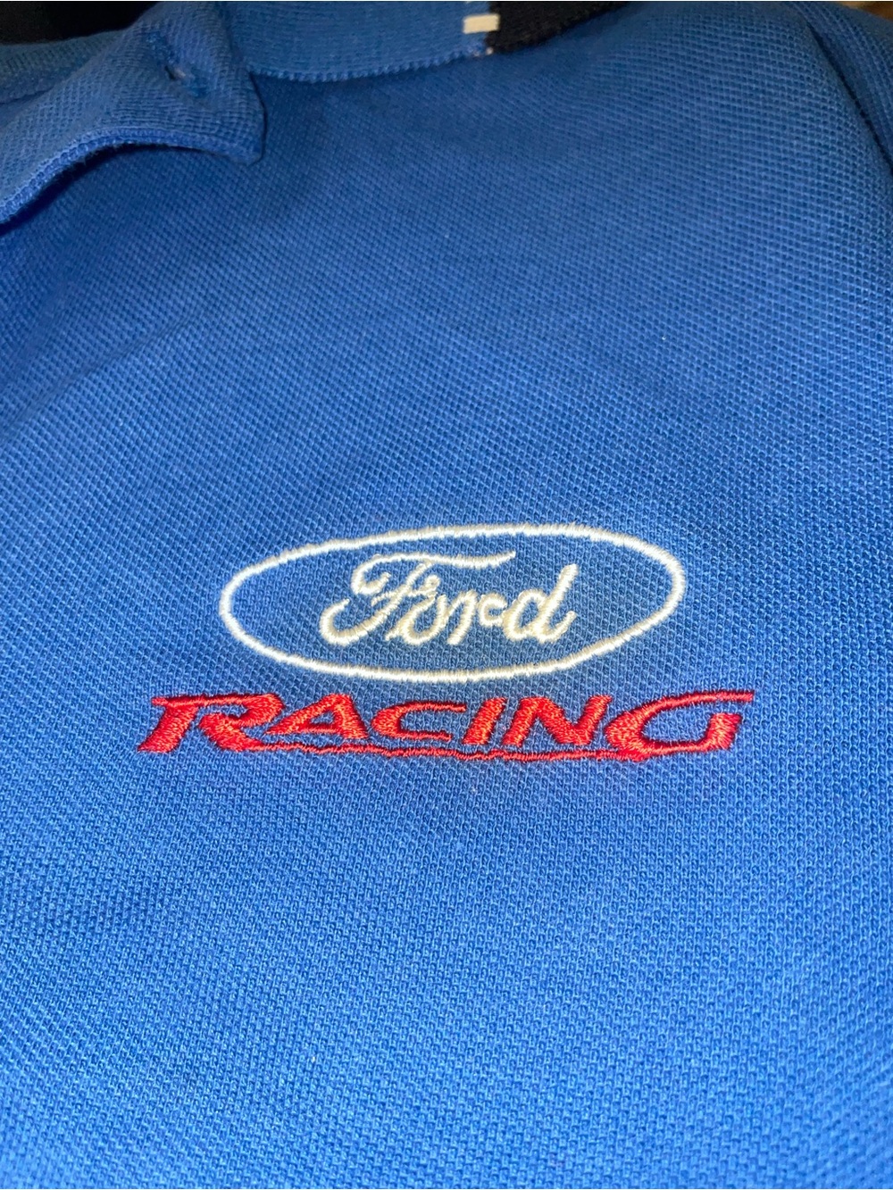 Ford Blue Polo with White Oval Logo and Red Racing Text